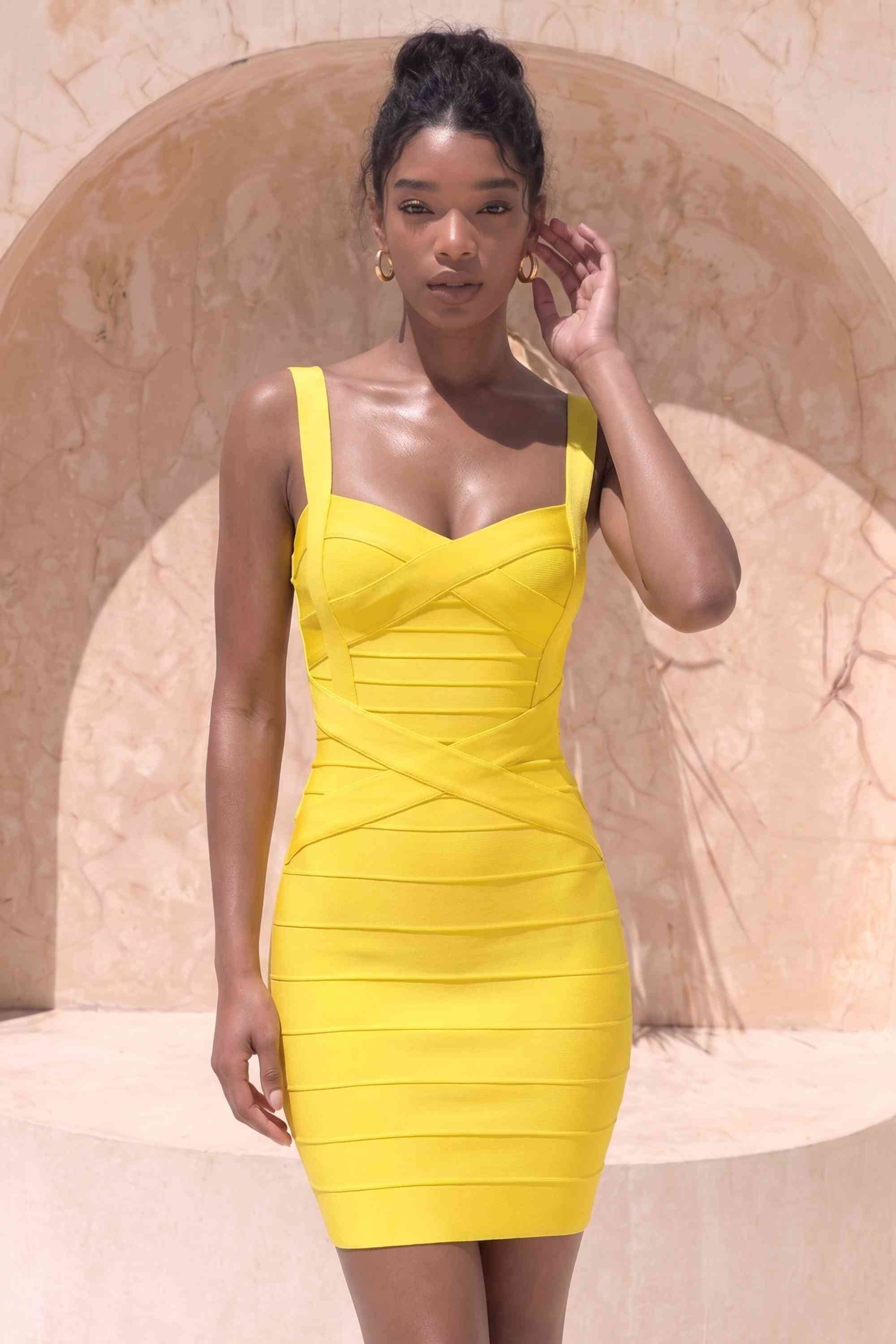Woman wearing a figure flattering  Heidi Bandage Mini Dress - Sun Yellow Bodycon Collection