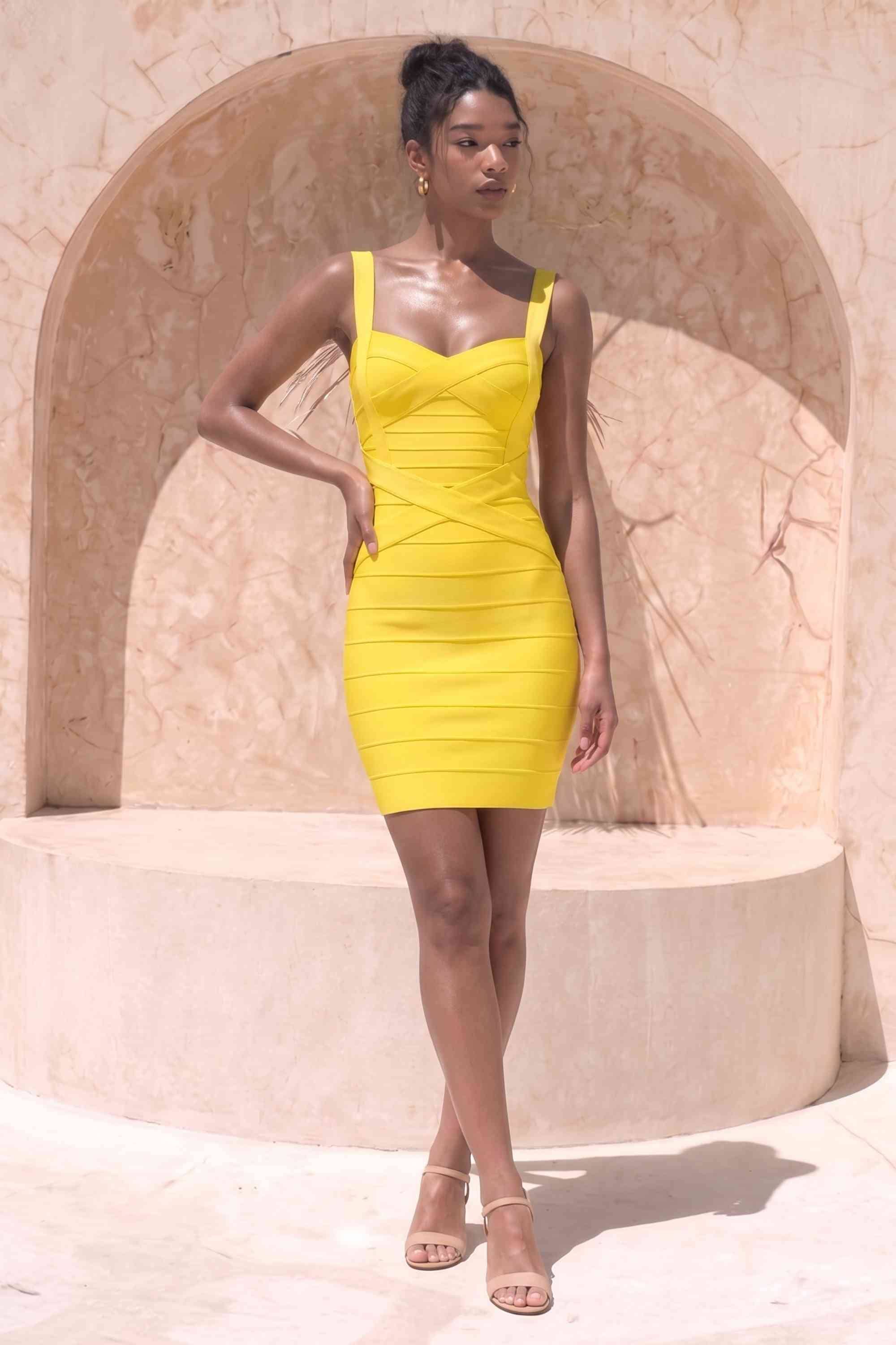 Woman wearing a figure flattering  Heidi Bandage Mini Dress - Sun Yellow Bodycon Collection