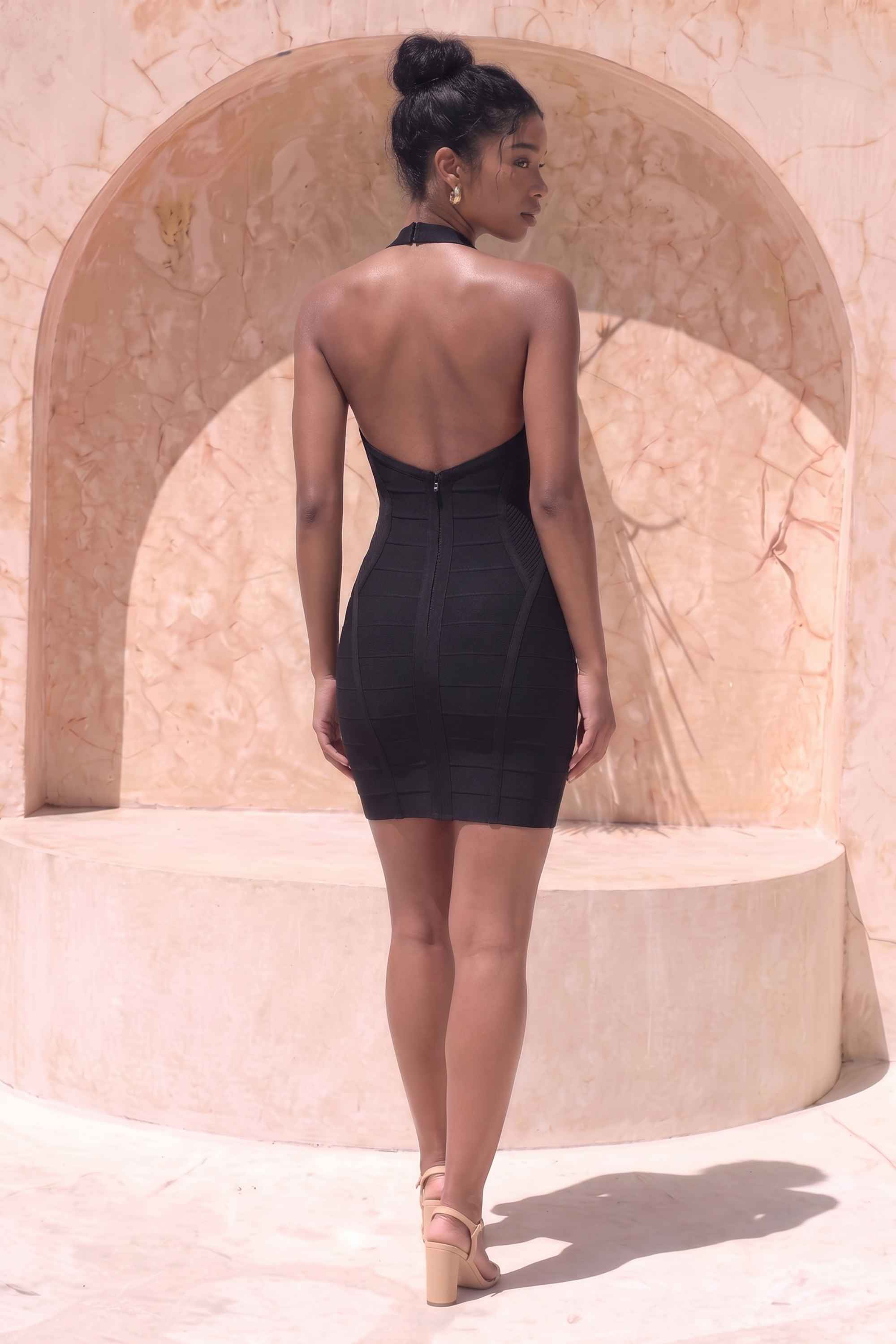 Woman wearing a figure flattering  Isabella Bandage Mini Dress - Classic Black BODYCON COLLECTION Pty Ltd