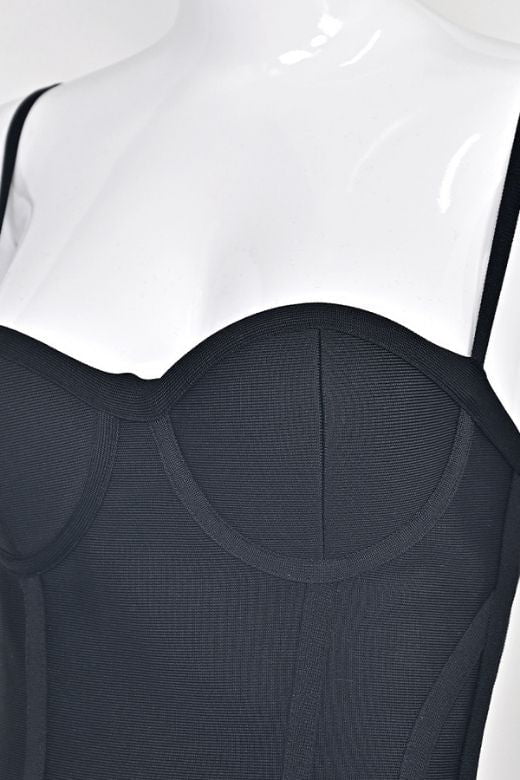 Woman wearing a figure flattering  Joy Bandage Midi Dress - Classic Black Bodycon Collection