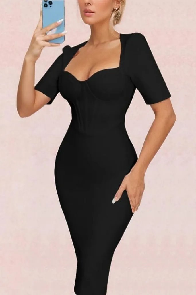 Woman wearing a figure flattering  Lola Short Sleeve Bodycon Midi Dress - Classic Black BODYCON COLLECTION