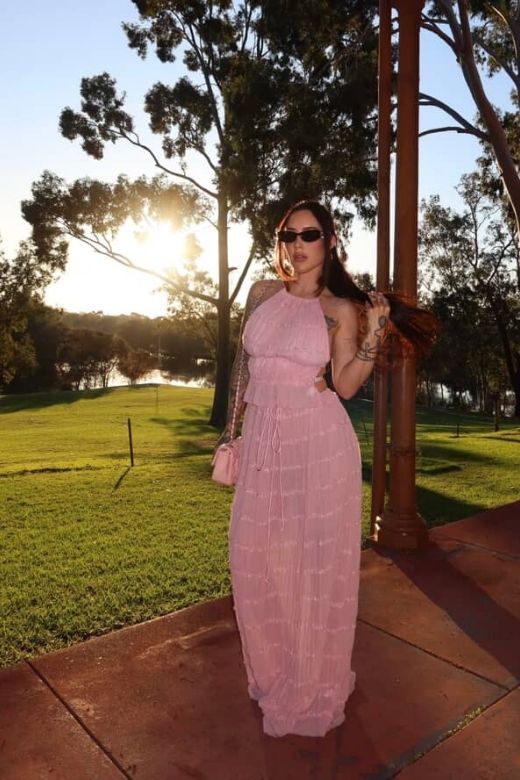 Woman wearing a figure flattering  Meryl Wrap Top and Maxi Skirt Set - Pink Fuzz BODYCON COLLECTION