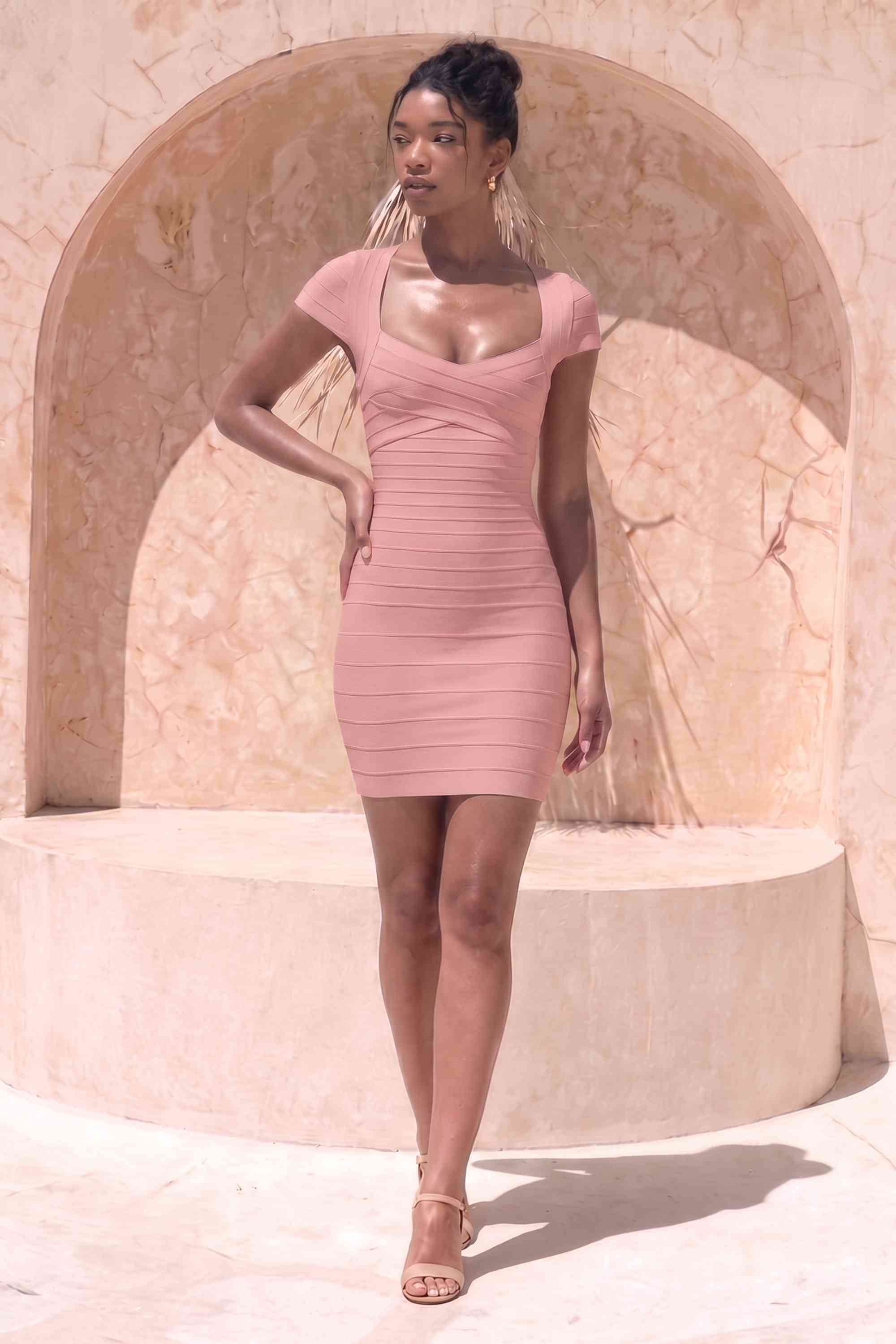Woman wearing a figure flattering  Miranda Bandage Mini Dress - Ballet Pink Bodycon Collection