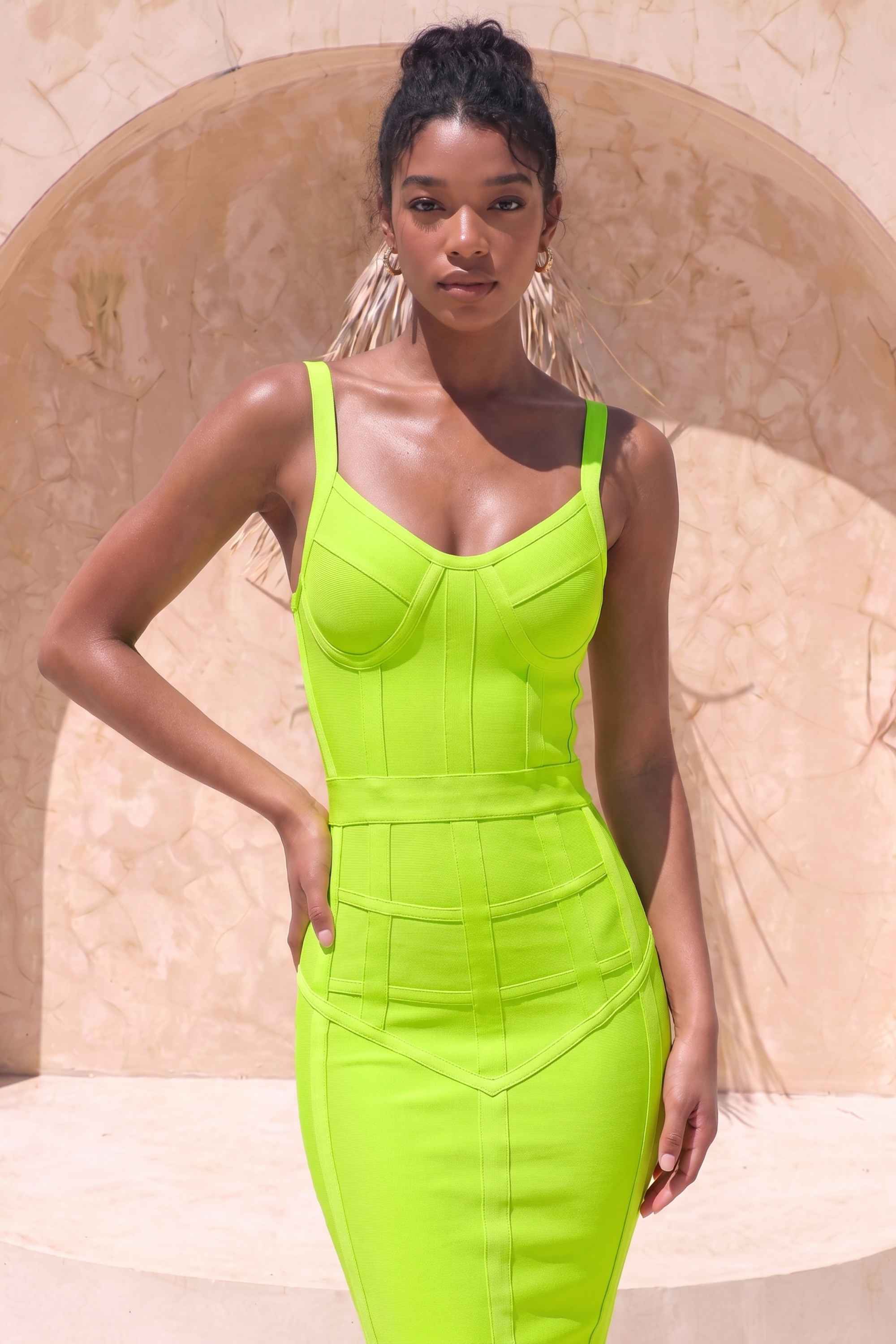 Woman wearing a figure flattering  Pip Bandage Corset Dress - Neon Green Bodycon Collection