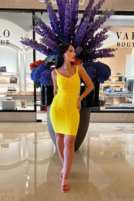 Woman wearing a figure flattering  Pip Bandage Mini Dress - Sun Yellow BODYCON COLLECTION