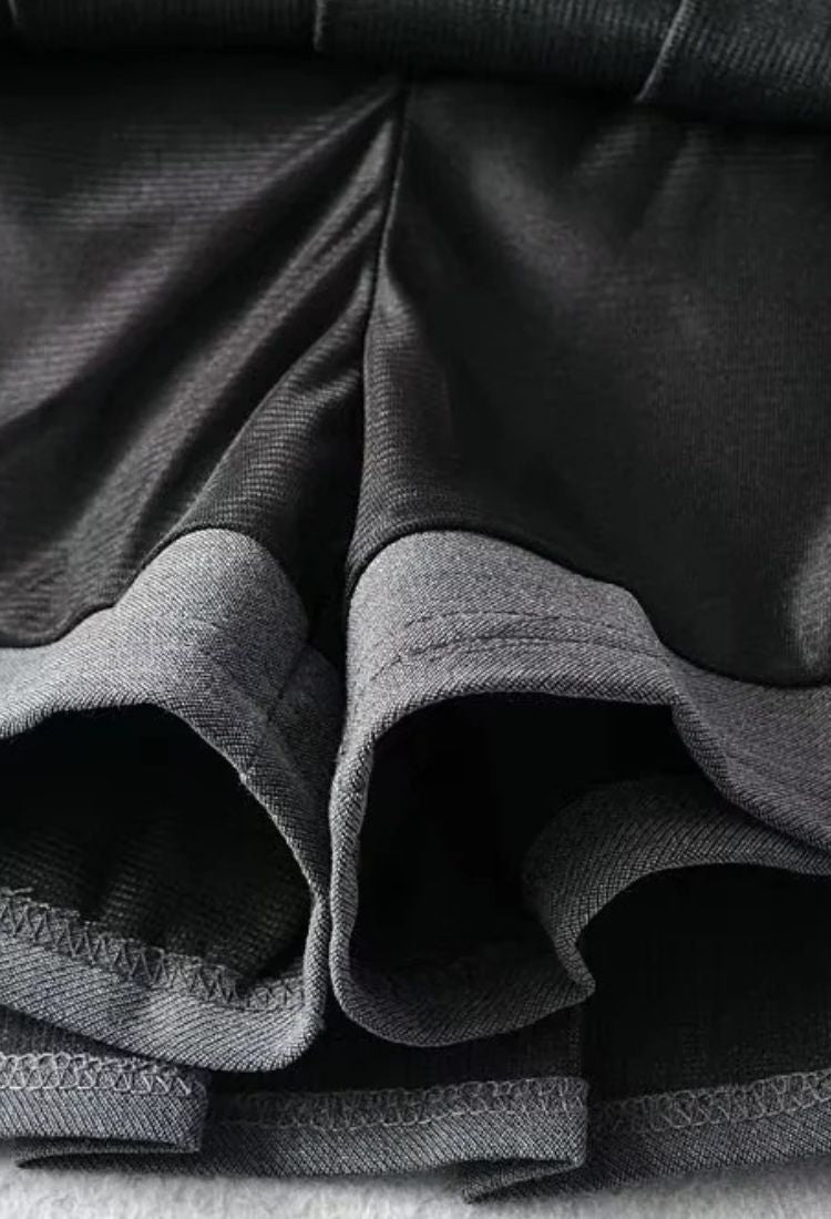 Woman wearing a figure flattering  Pleated Mini Skirt - Classic Black BODYCON COLLECTION Pty Ltd