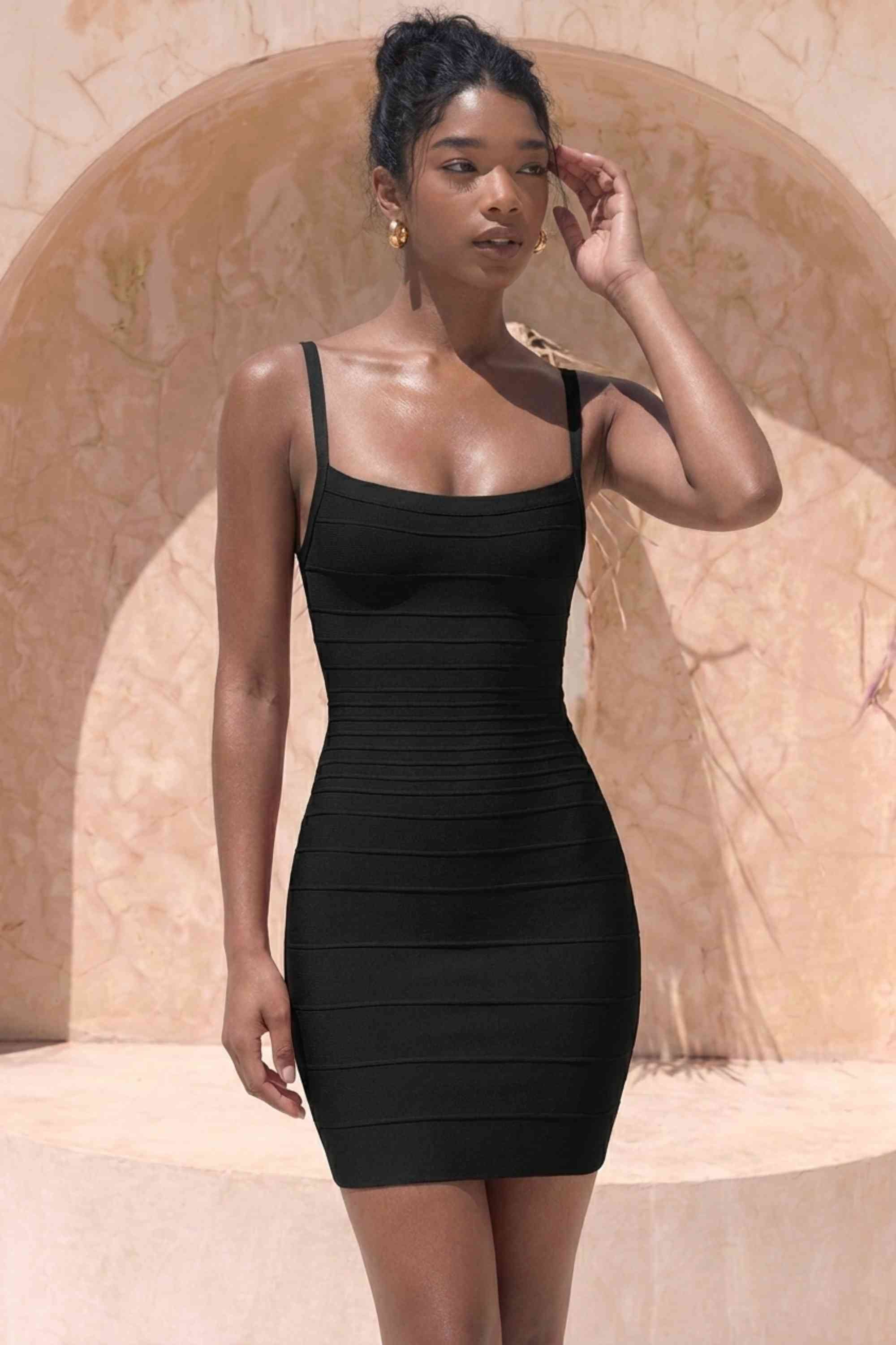 Woman wearing a figure flattering  Scarlett Bandage Mini Dress - Classic Black BODYCON COLLECTION Pty Ltd