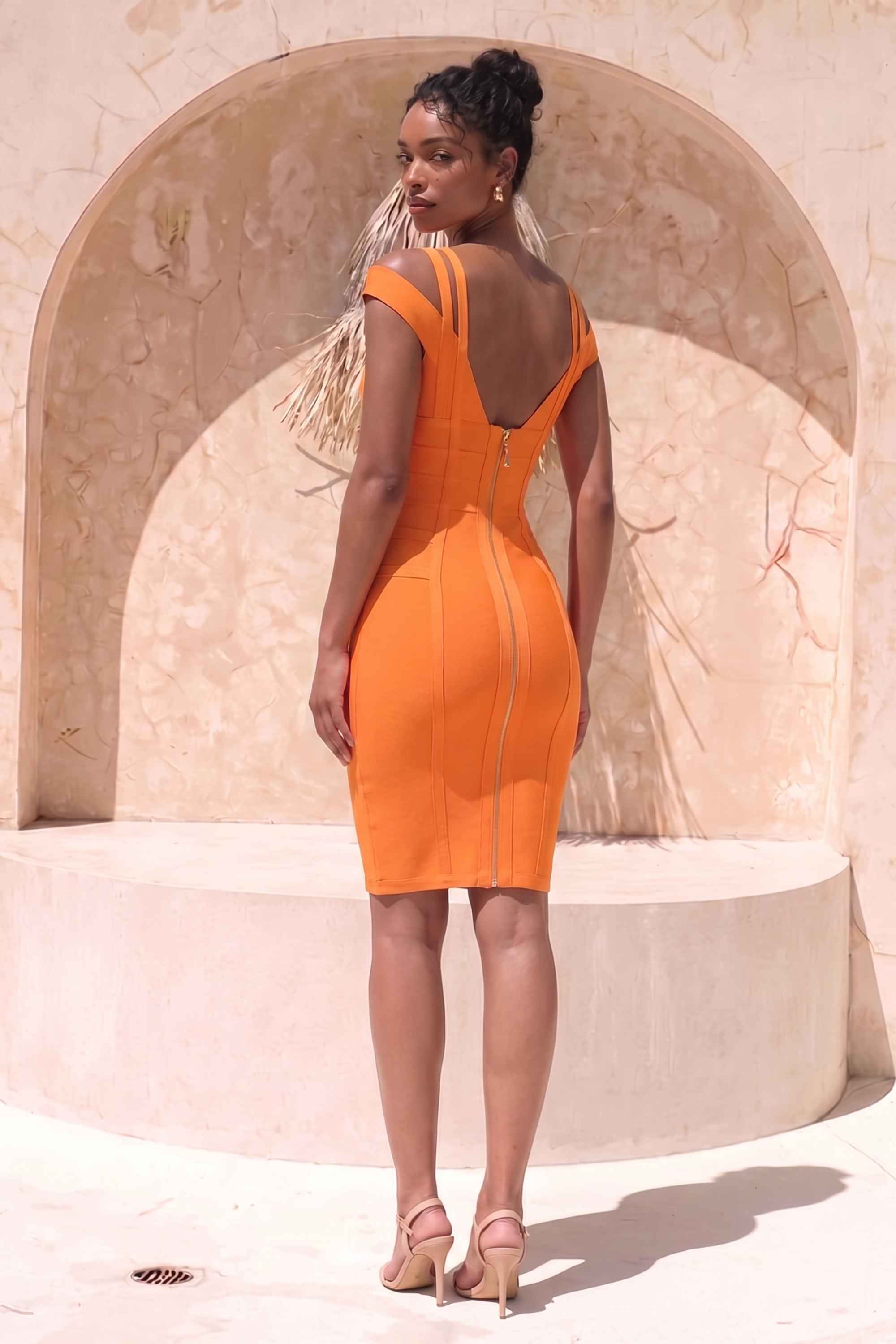 Woman wearing a figure flattering  Sia Bandage Dress - Apricot Orange Bodycon Collection