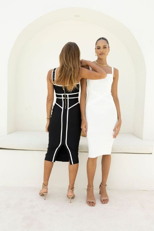 Woman wearing a figure flattering  Suki Bandage Midi Dress - Classic Black BODYCON COLLECTION