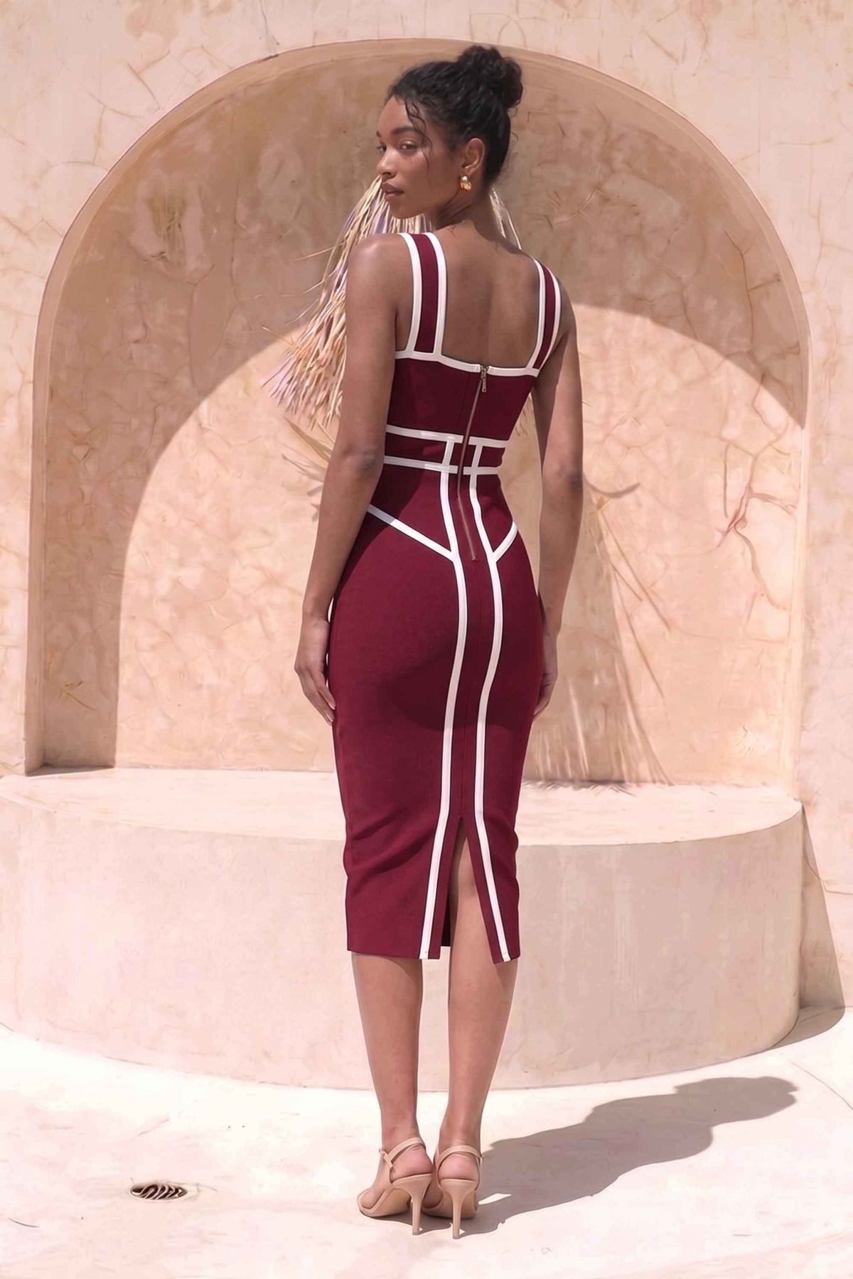 Woman wearing a figure flattering  Suki Bandage Midi Dress - Red Wine BODYCON COLLECTION