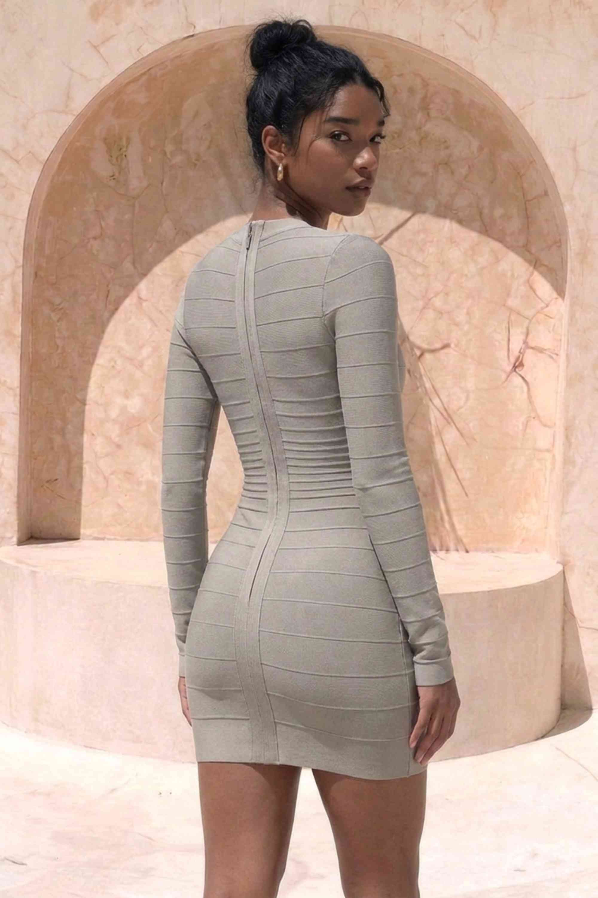 Woman wearing a figure flattering  Valentina Long Sleeve Bandage Mini Dress - Oyster Grey BODYCON COLLECTION Pty Ltd