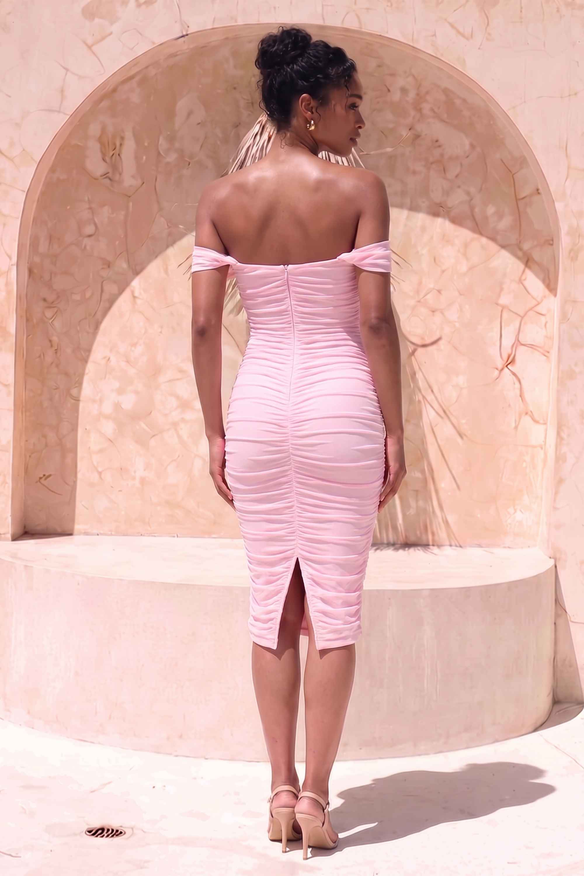 Woman wearing a figure flattering  Zia Bodycon Wrap Midi Dress - Dusty Pink Bodycon Collection